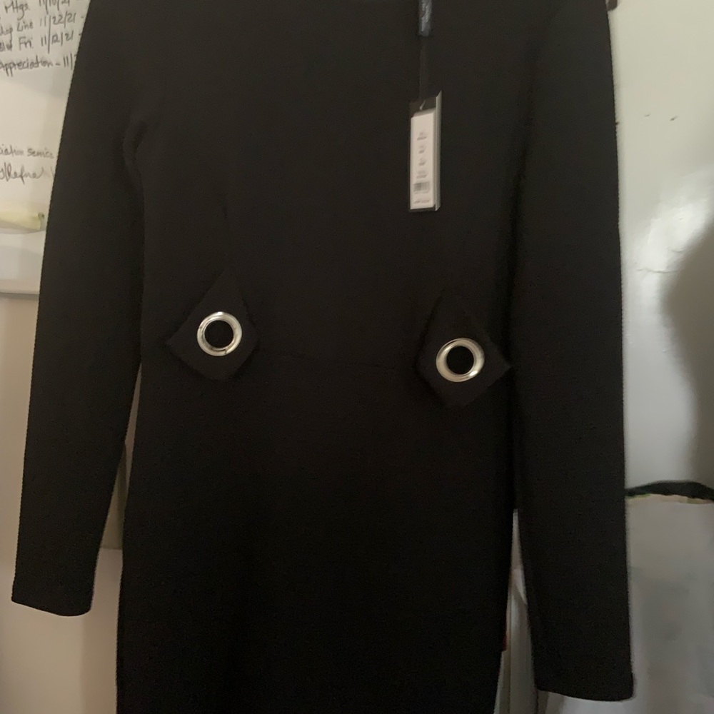Lovely black dress with silver large eyelets on the front